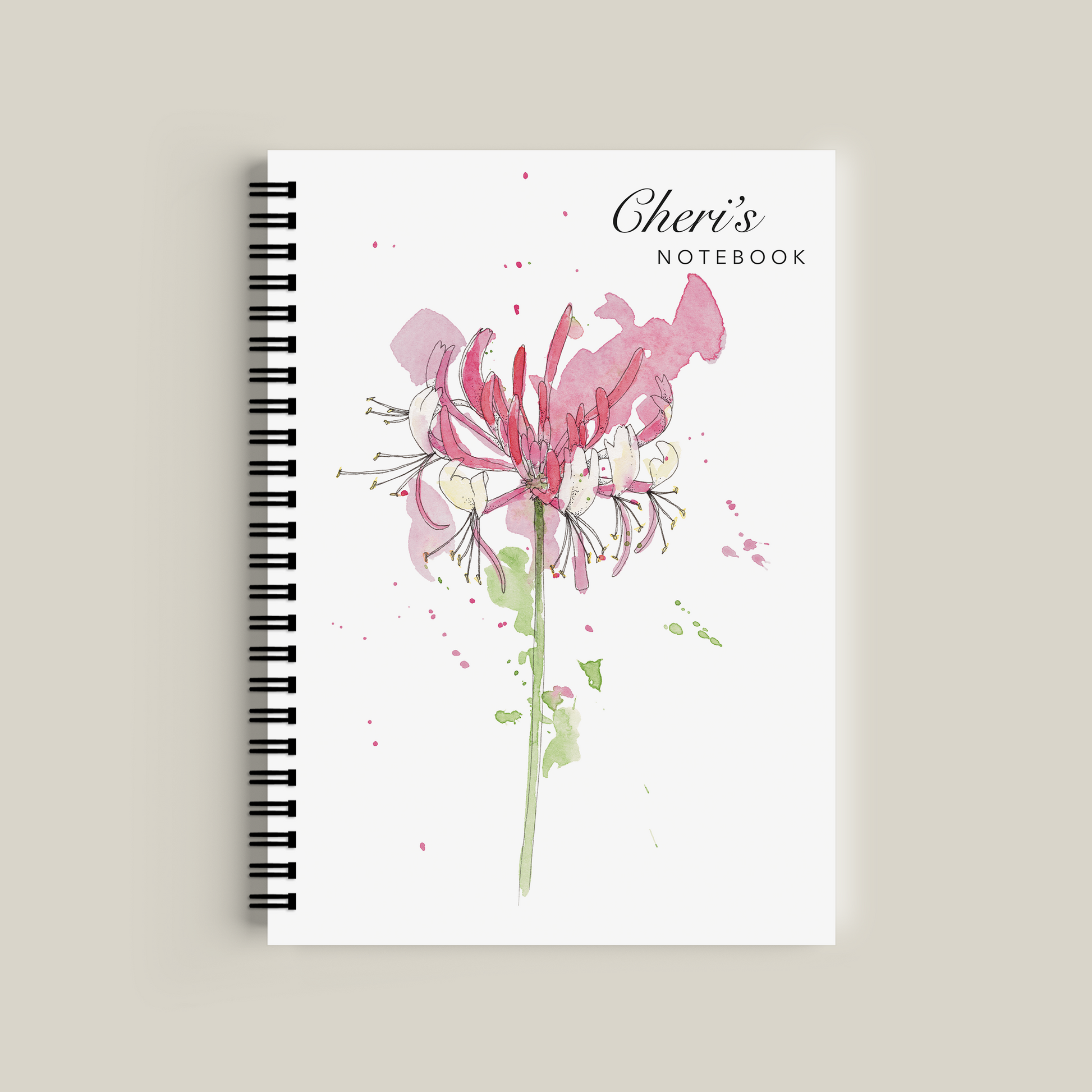 Notebook with floral design and 'Cheri's' branding on a beige background