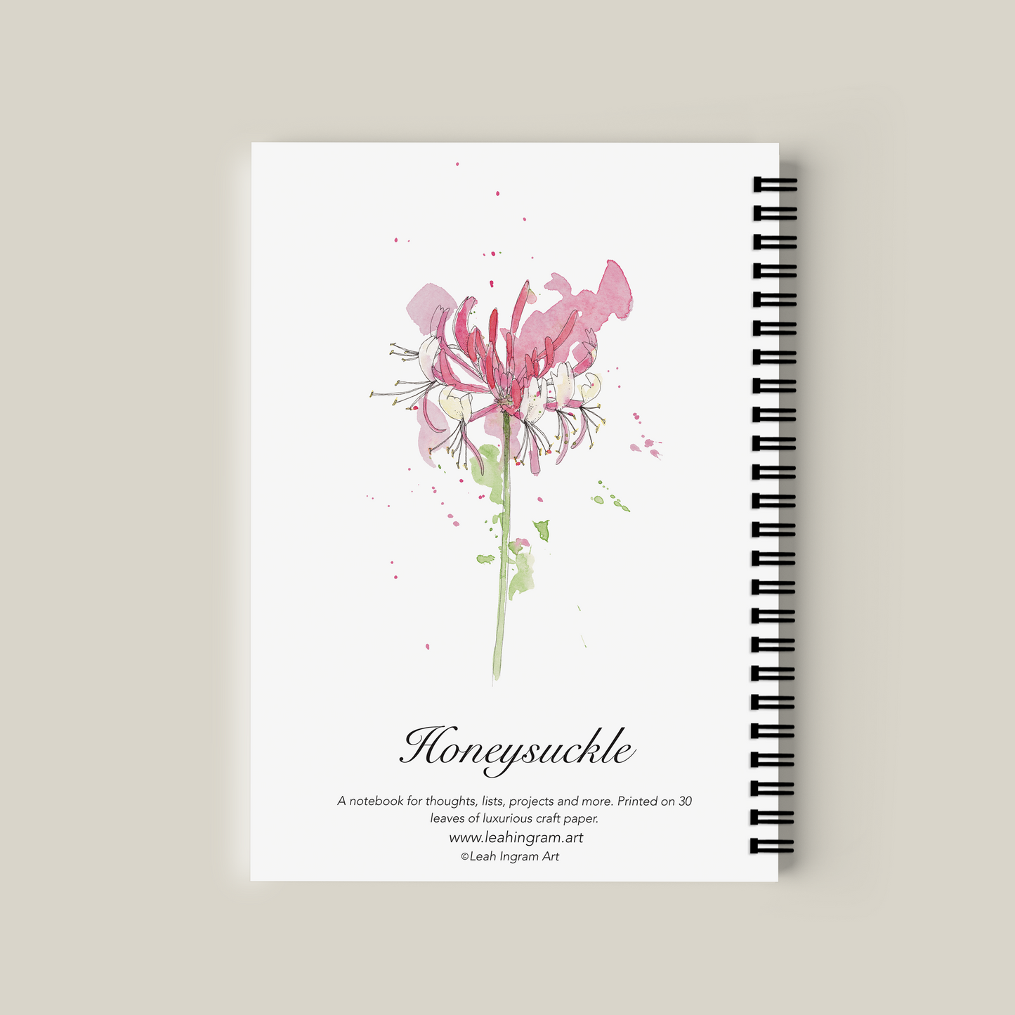 Notebook with pink flower design on a beige background