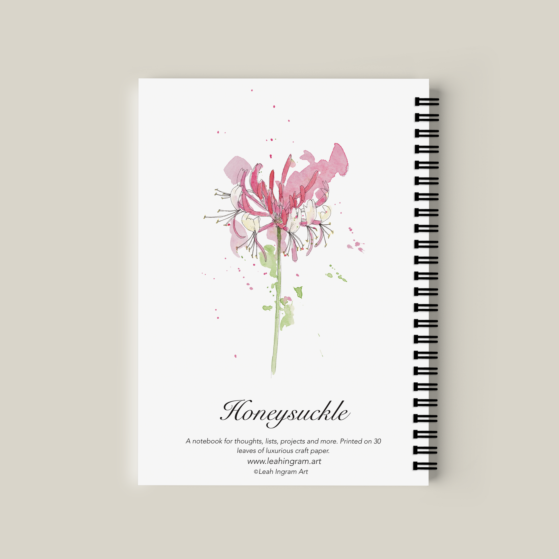 Notebook with pink flower design on a beige background