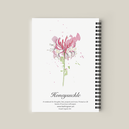 Notebook with pink flower design on a beige background