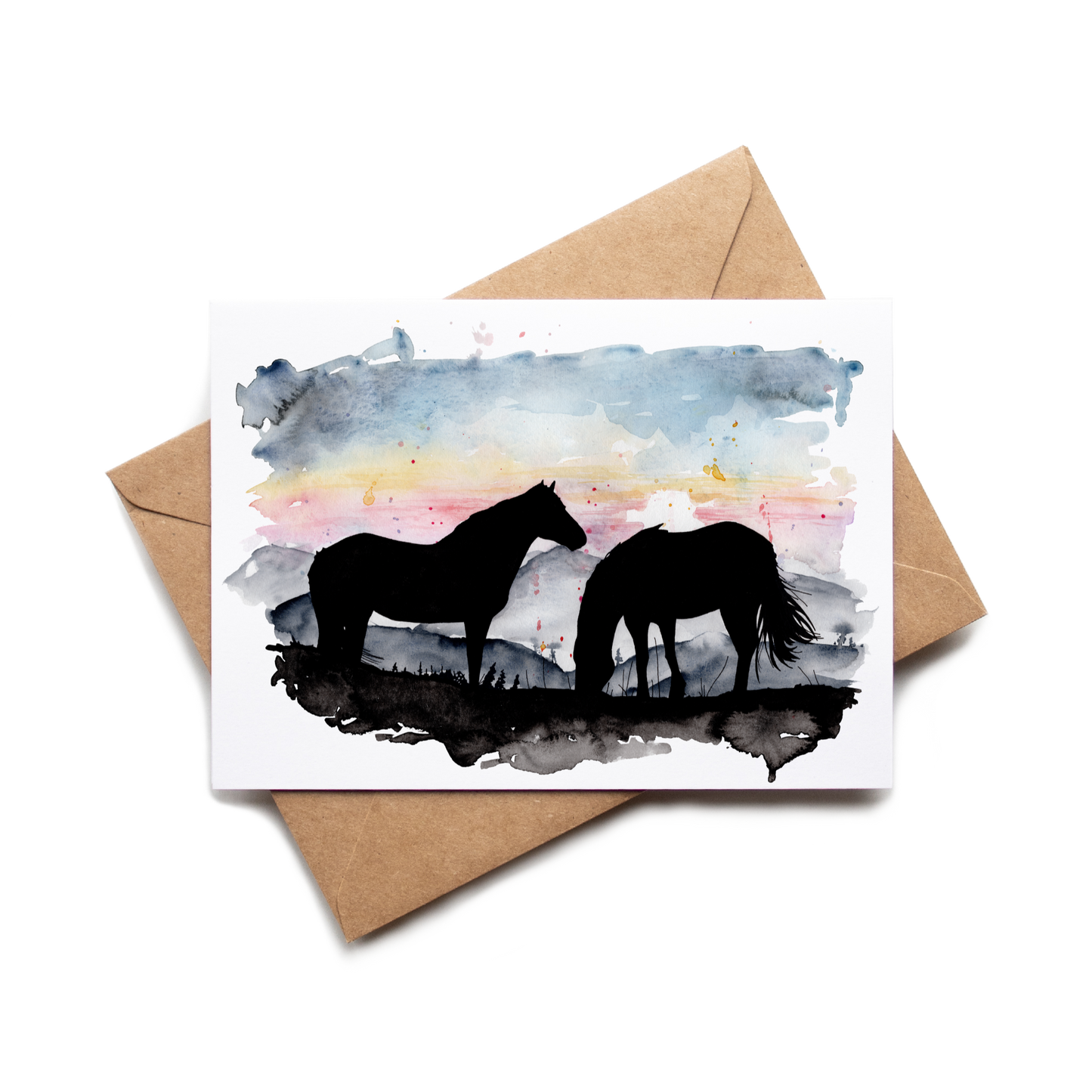 Card with horse silhouette design on a watercolor background, placed on a brown envelope.