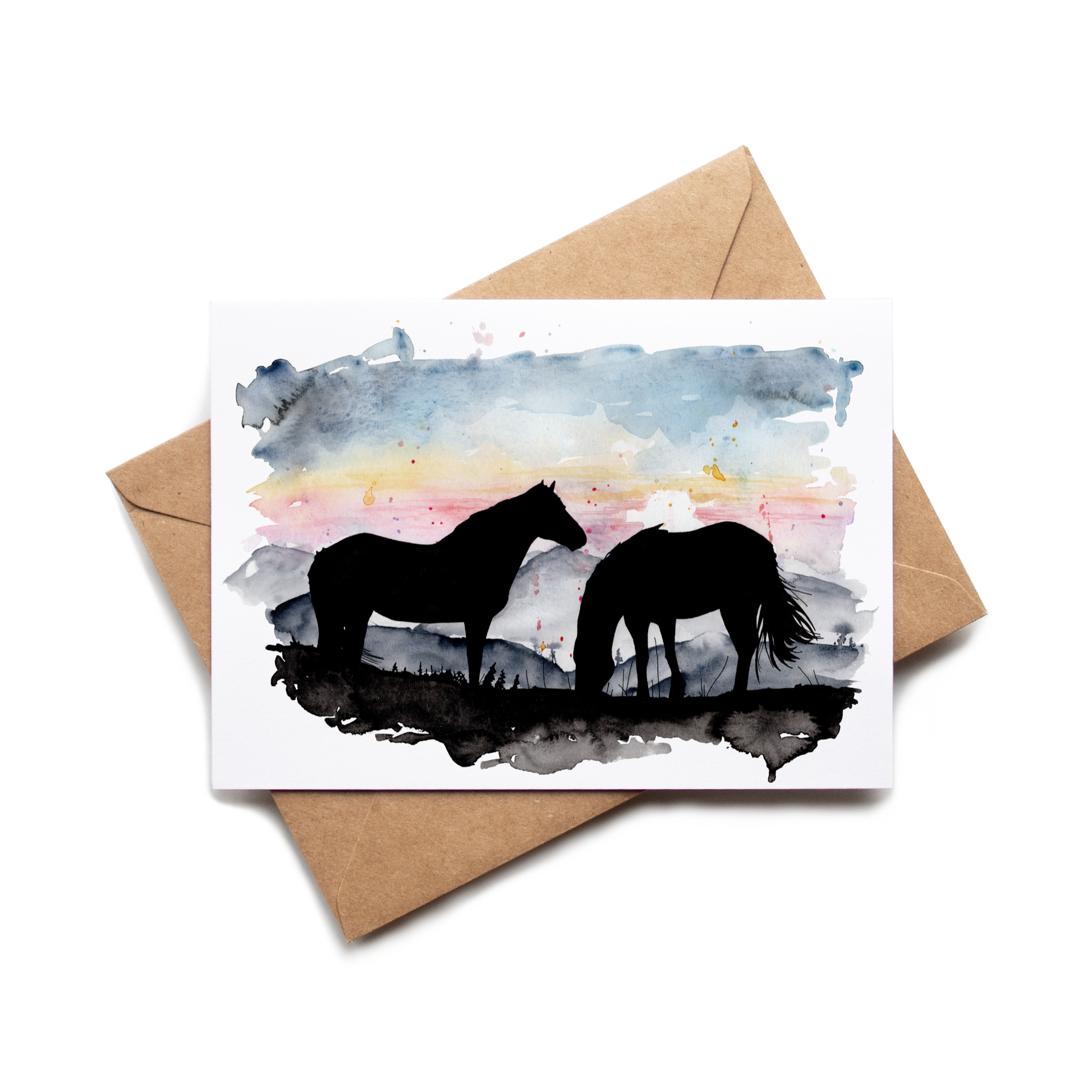 Card with horse silhouette design on a watercolor background, placed on a brown envelope.