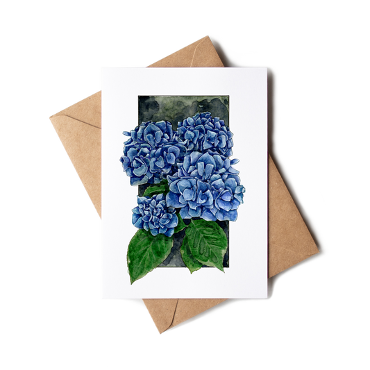 Greeting card with blue hydrangea flowers and a brown envelope on a white background