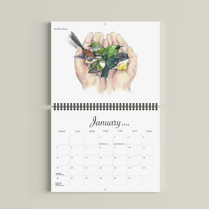 Calendar with illustration of hands holding birds on a beige background