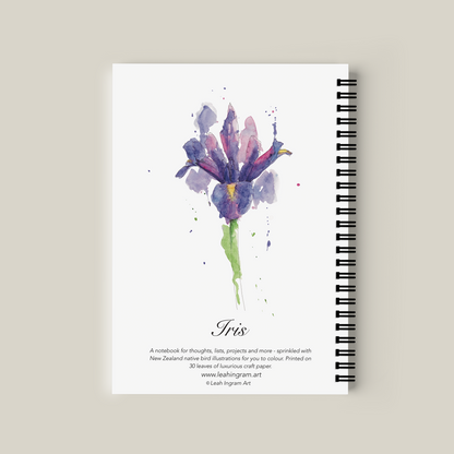 Notebook with watercolor iris design on the cover against a beige background