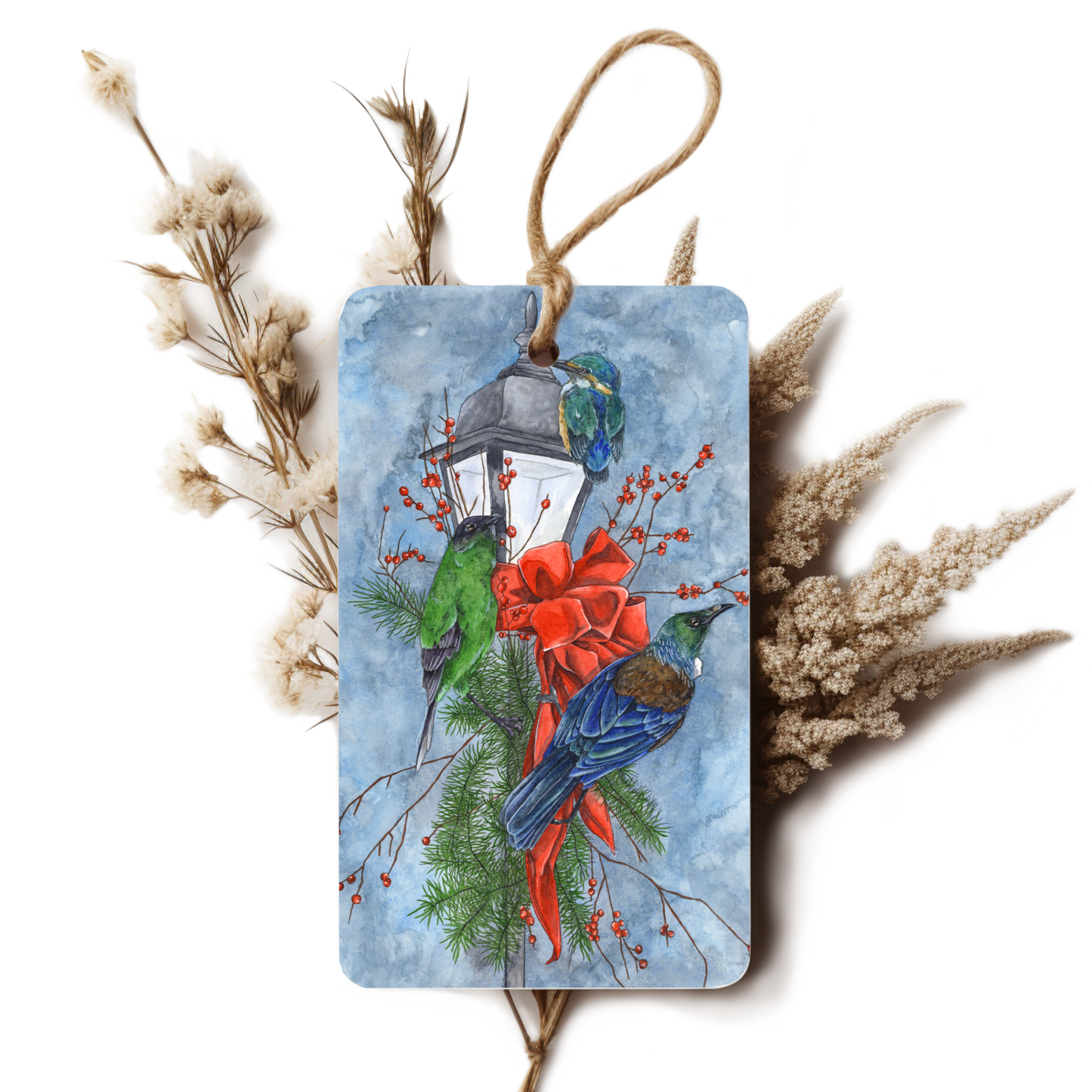 Decorative tag with birds, a lantern, and red ribbon on a white background