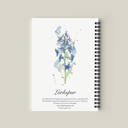 Notebook with floral design and text on a beige background