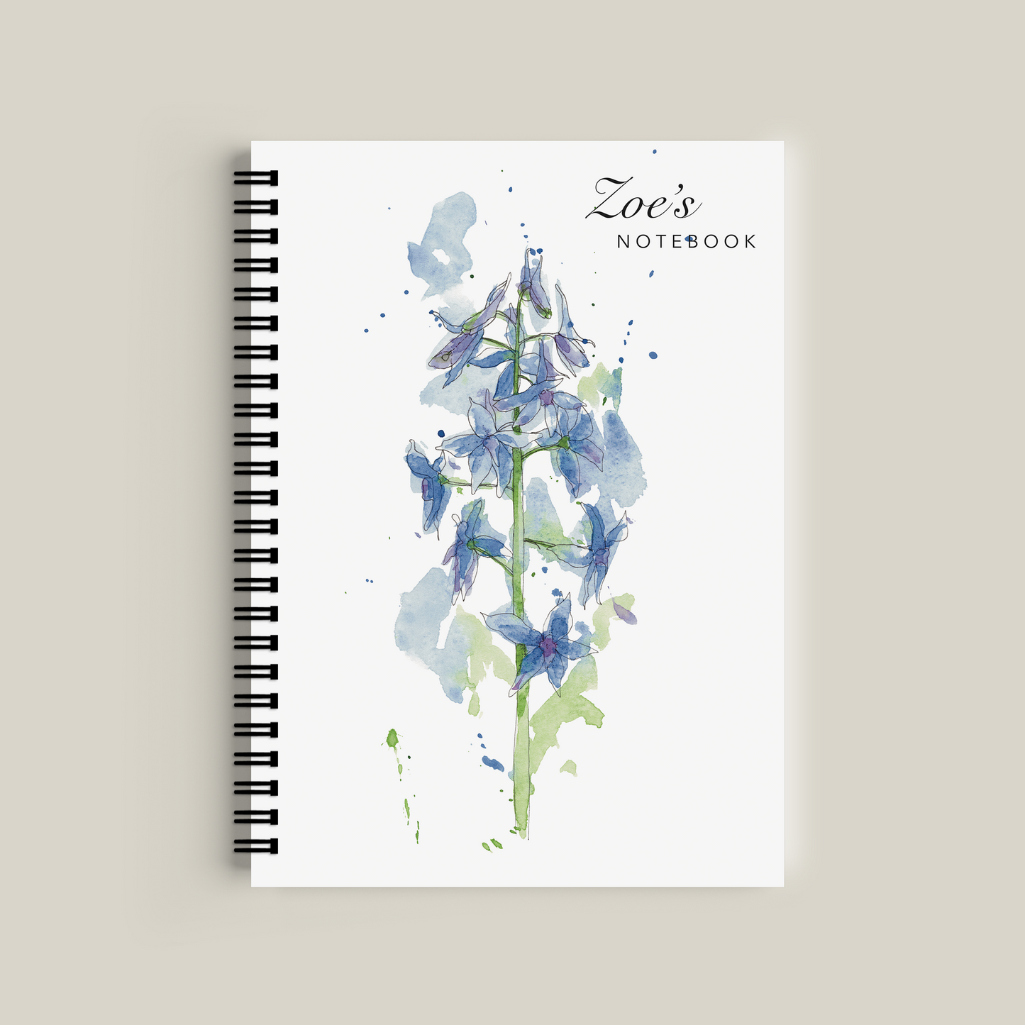 Notebook with floral design and 'Zoe's Notebook' text on a beige background