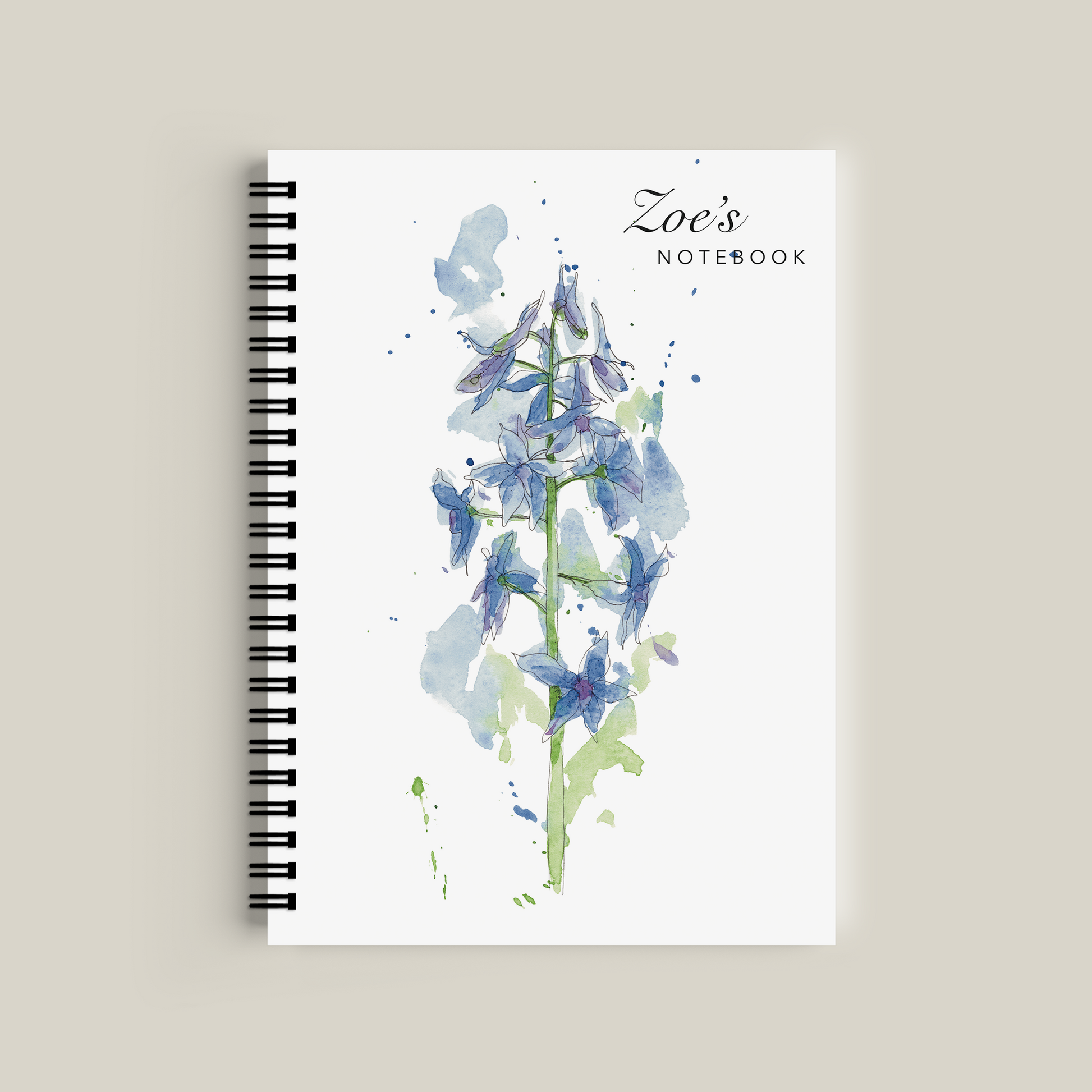 Notebook with floral design and 'Zoe's Notebook' text on a beige background