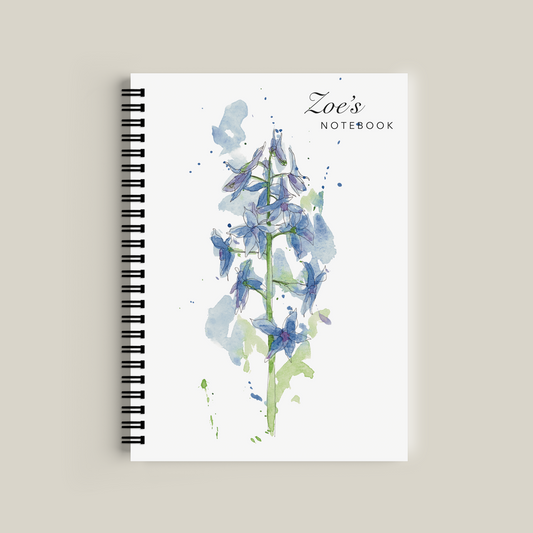 Notebook with floral design and 'Zoe's Notebook' text on a beige background