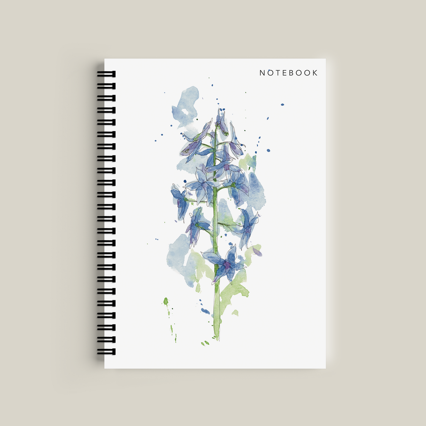 Notebook with blue floral design on a beige background