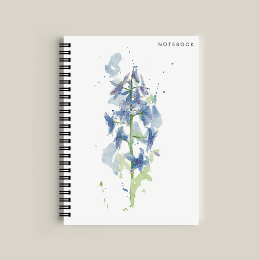 Notebook with blue floral design on a beige background