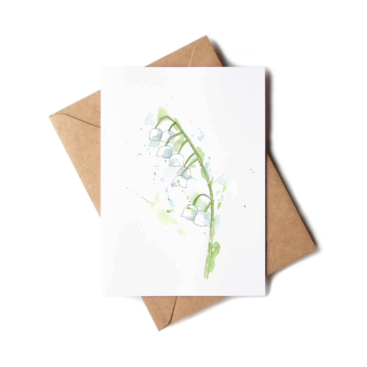 Greeting card with floral design and brown envelope on white background