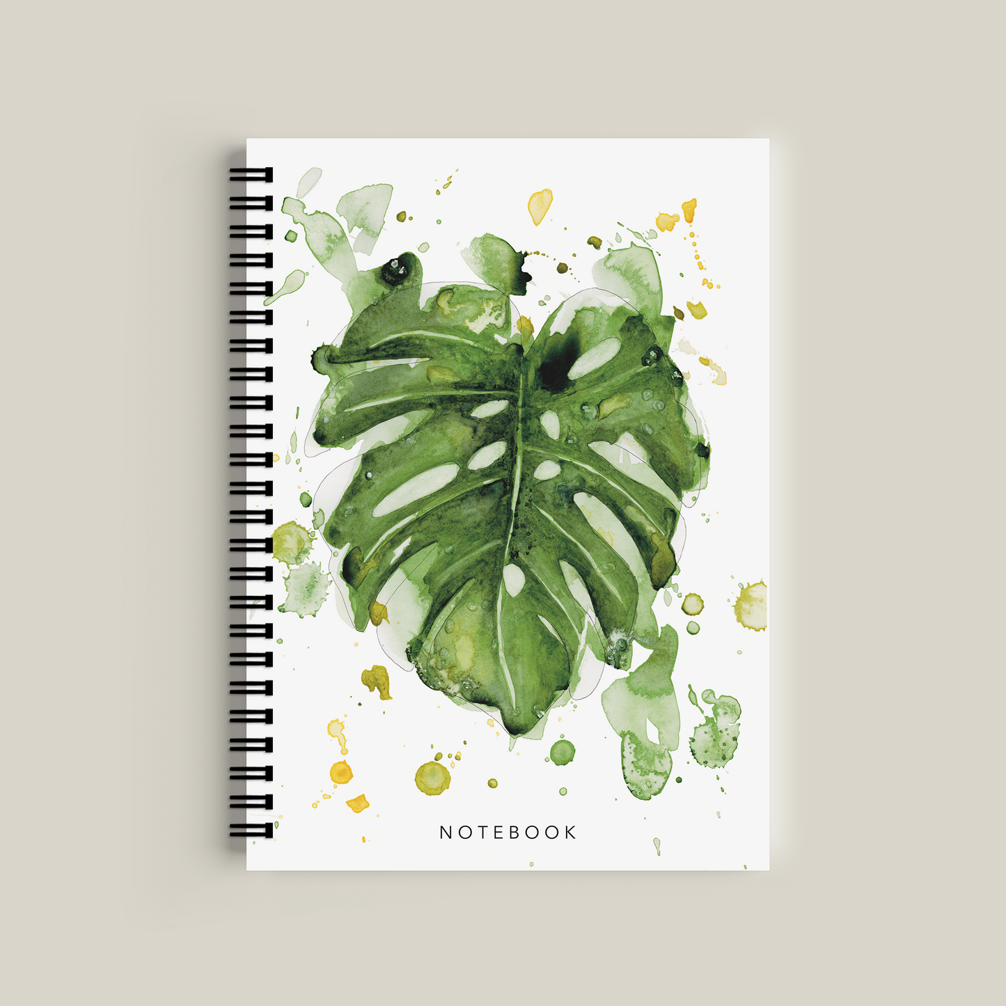 Notebook with green leaf design on a white background