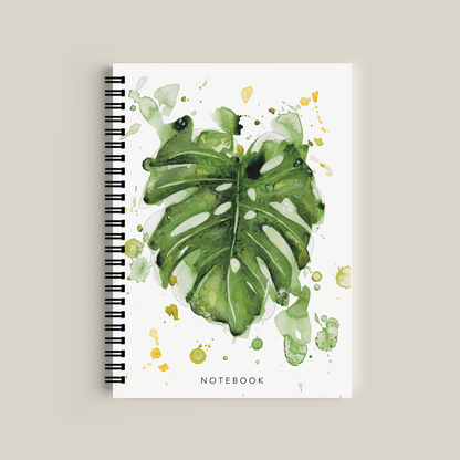 Notebook with green leaf design on a white background