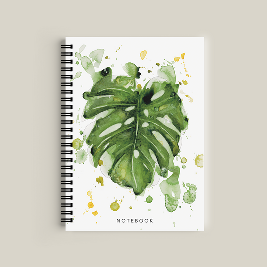 Notebook with green leaf design on a white background