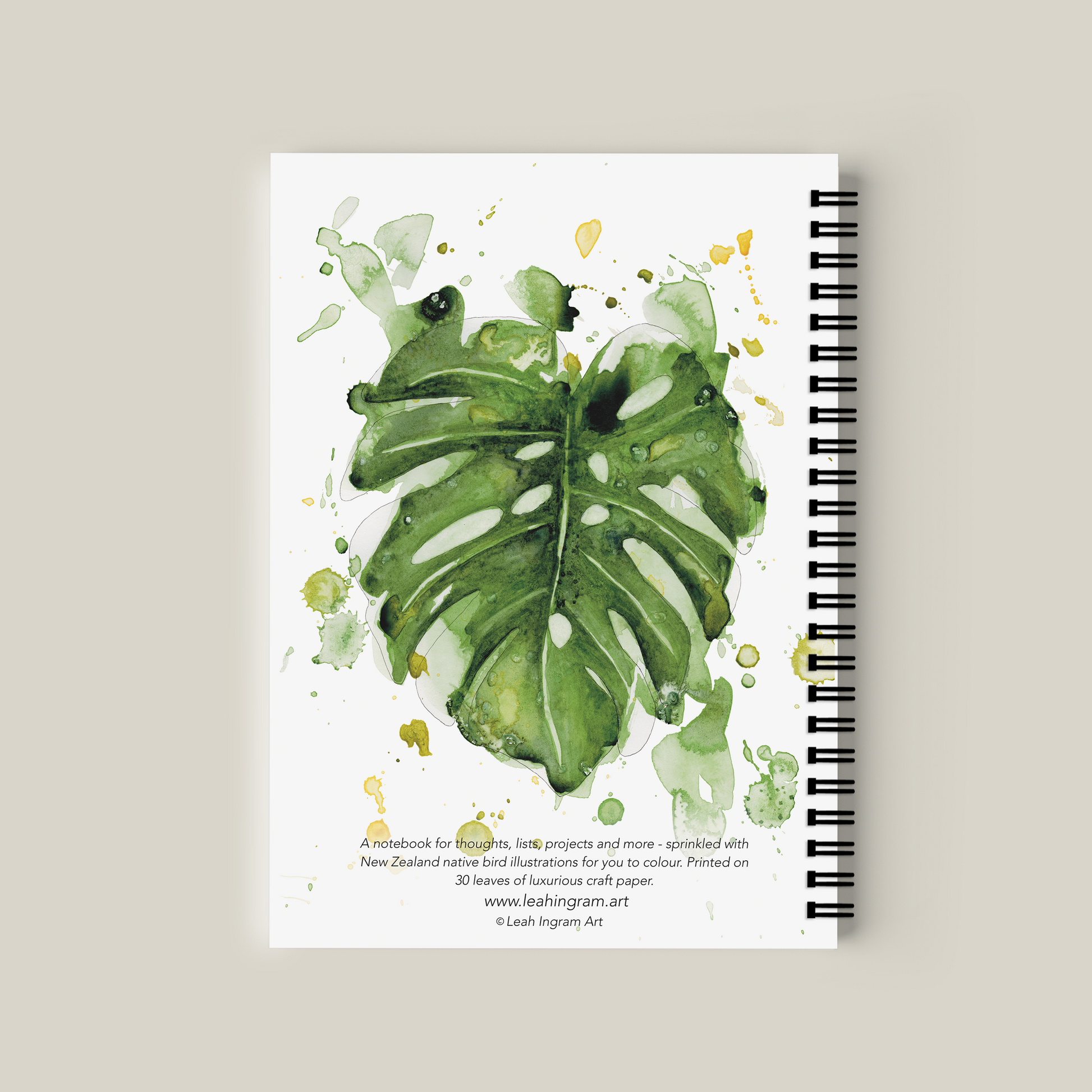 Notebook with green leaf design on a beige background