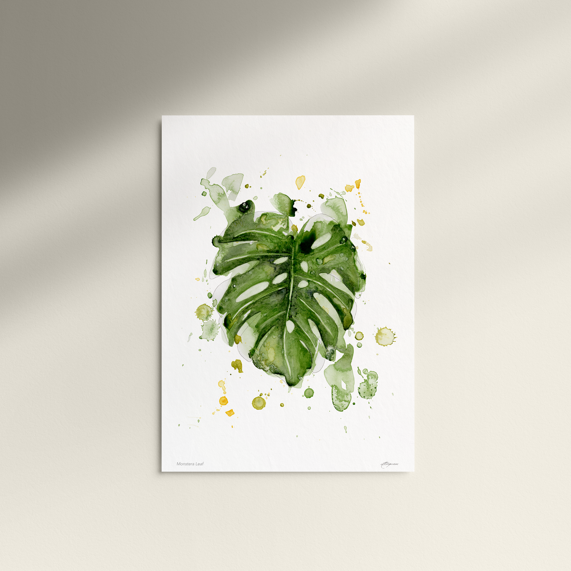 Framed artwork of green leaves on a white background