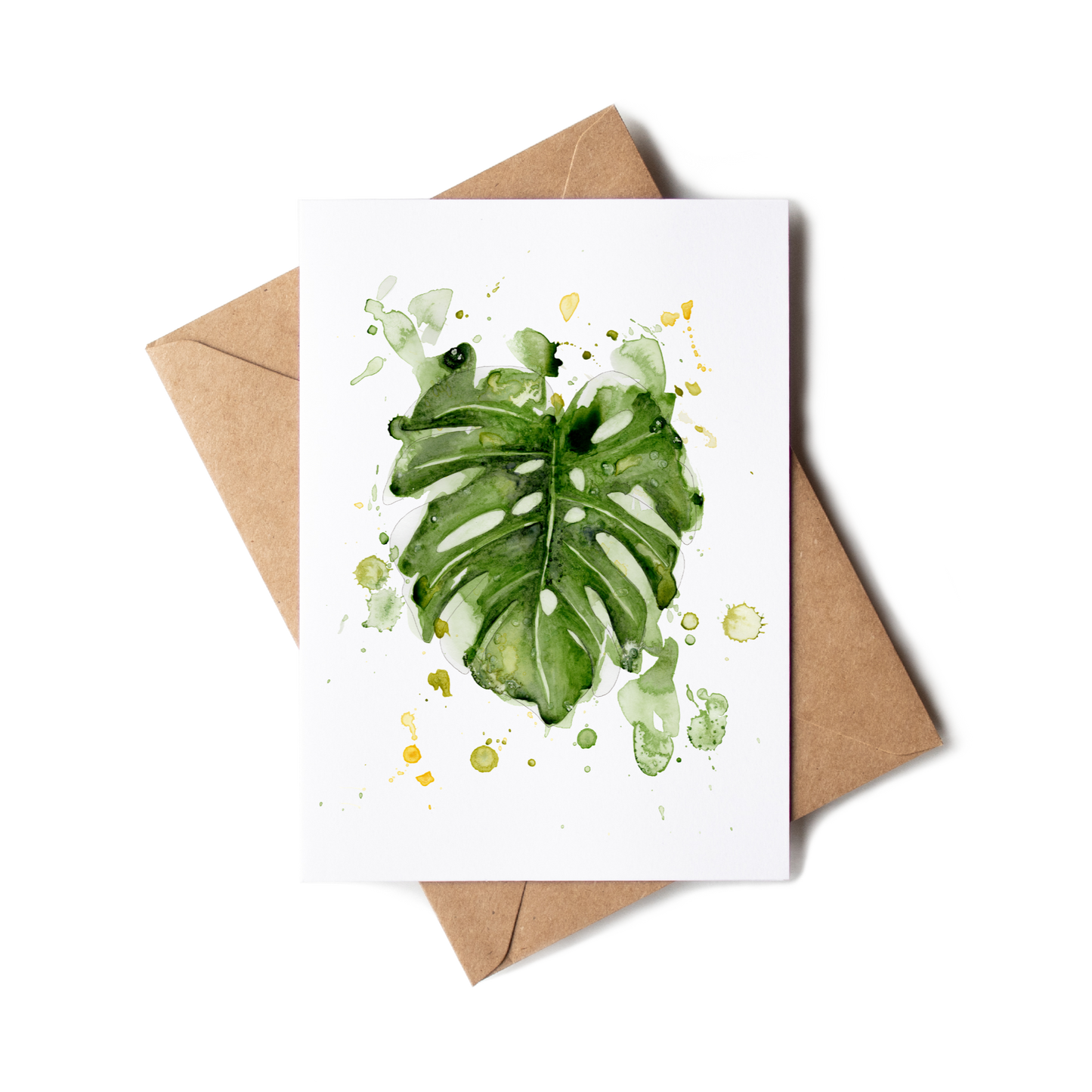 Greeting card with green leaf design on a white background, accompanied by a brown envelope.