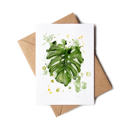 Greeting card with green leaf design on a white background, accompanied by a brown envelope.