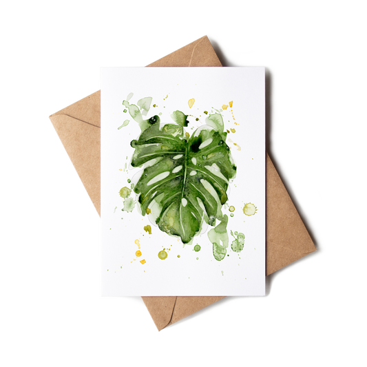 Greeting card with green leaf design on a white background, accompanied by a brown envelope.