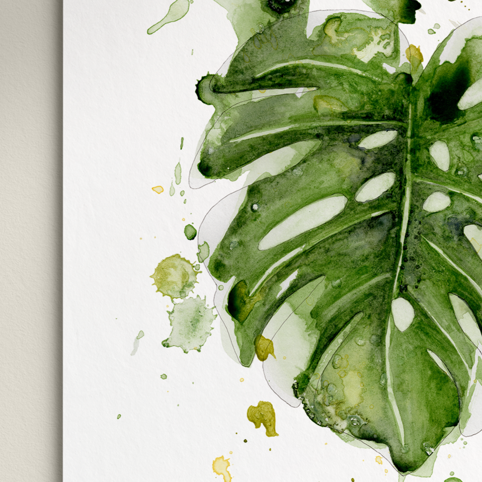 Framed artwork of green leaves on a white background