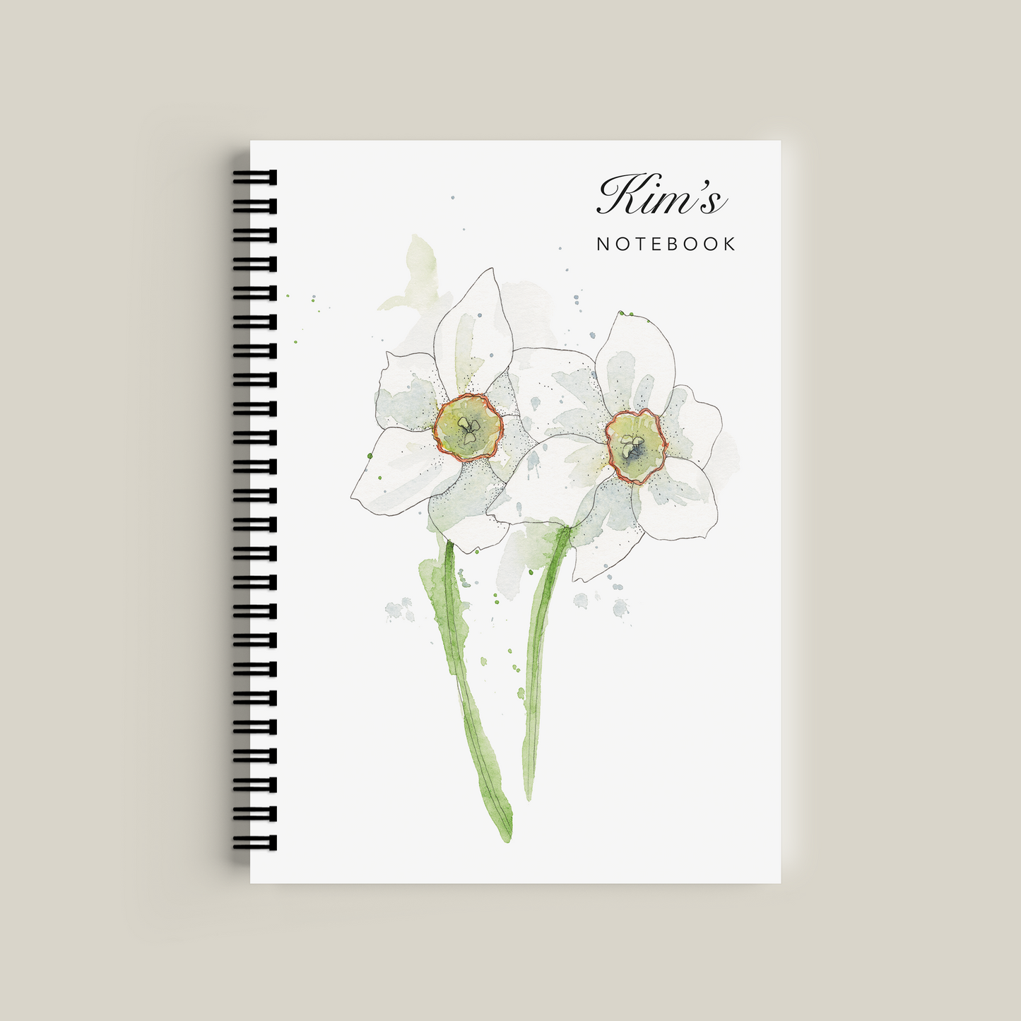 Notebook with floral design and 'Kim's Notebook' text on a beige background