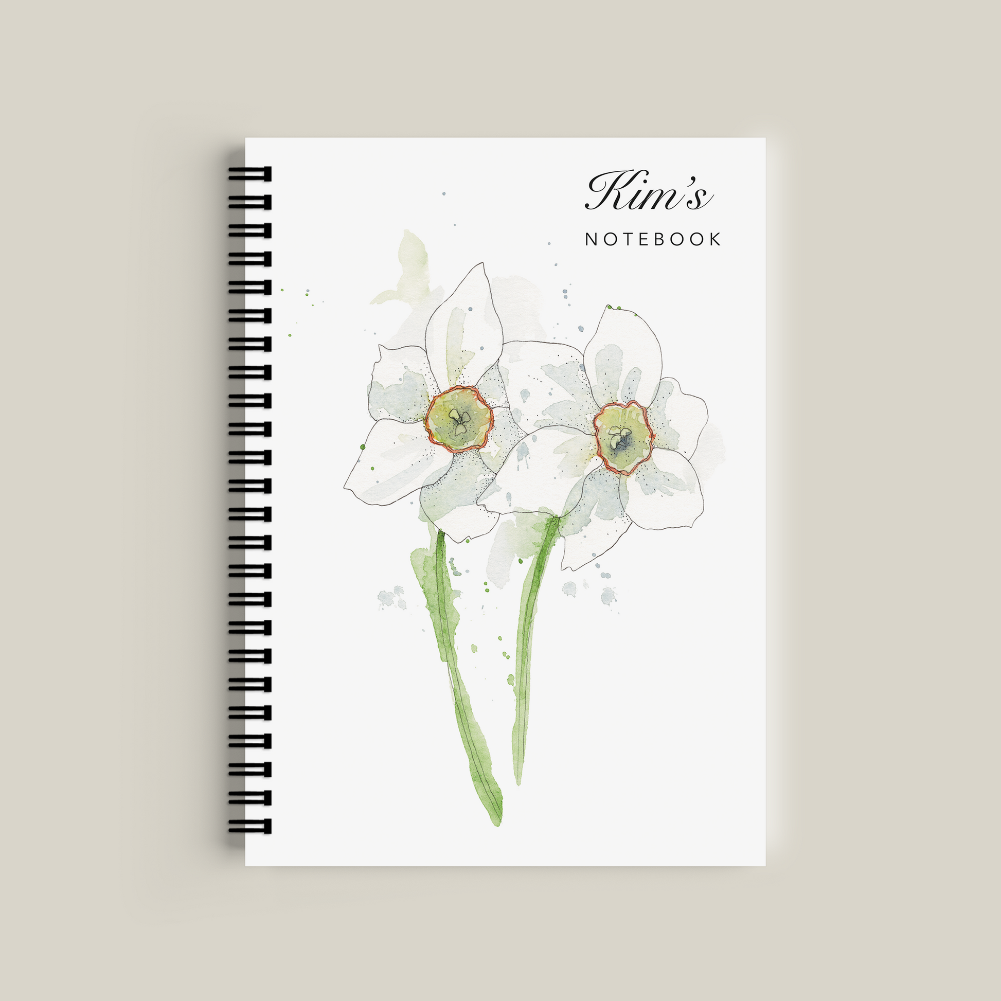 Notebook with floral design and 'Kim's Notebook' text on a beige background