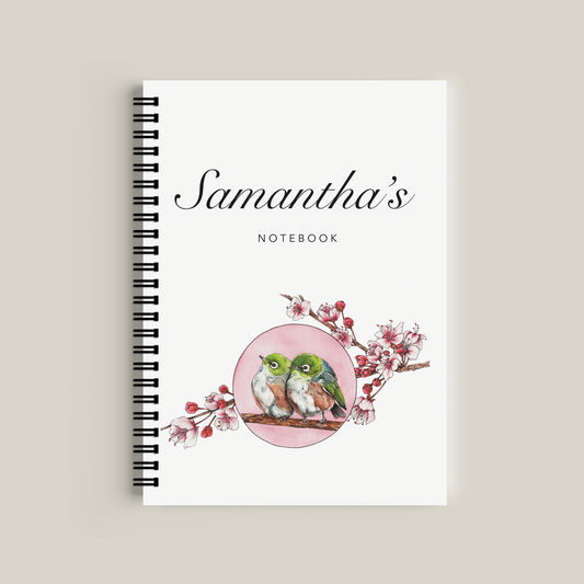 Notebook with 'Samantha's Notebook' text and bird design on a beige background