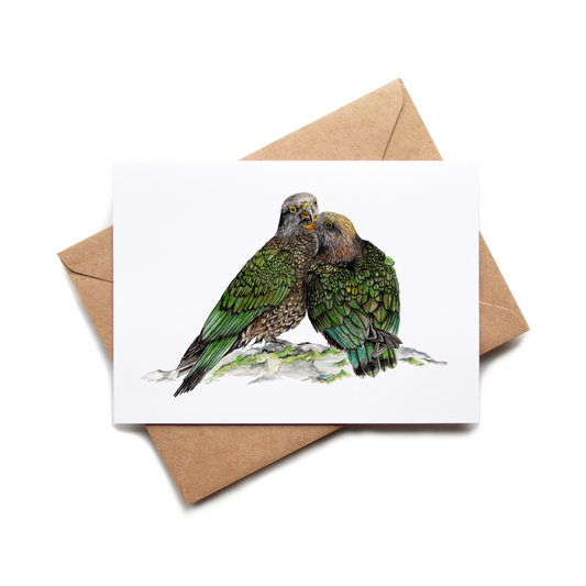 Card with illustration of two green parrots on a white background with a brown envelope.