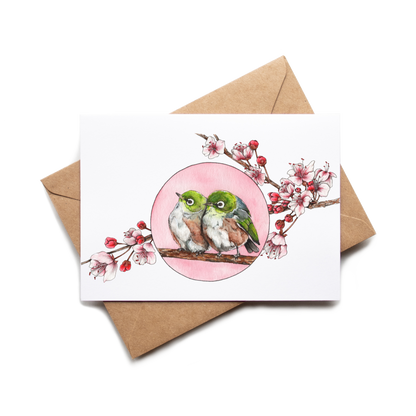 Card with two birds and a pink circle on a white background