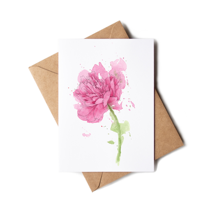 Greeting card with pink flower design and brown envelope on white background