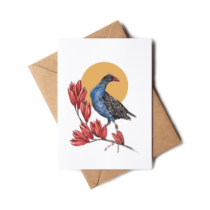 Greeting card with a bird and red flowers design on a white background with a brown envelope.