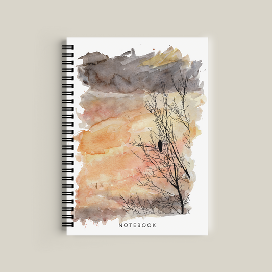 Notebook with watercolor design of a tree and bird on a beige background