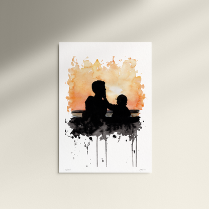 Art print of a silhouette of a father and child against an abstract watercolor background on a white wall.