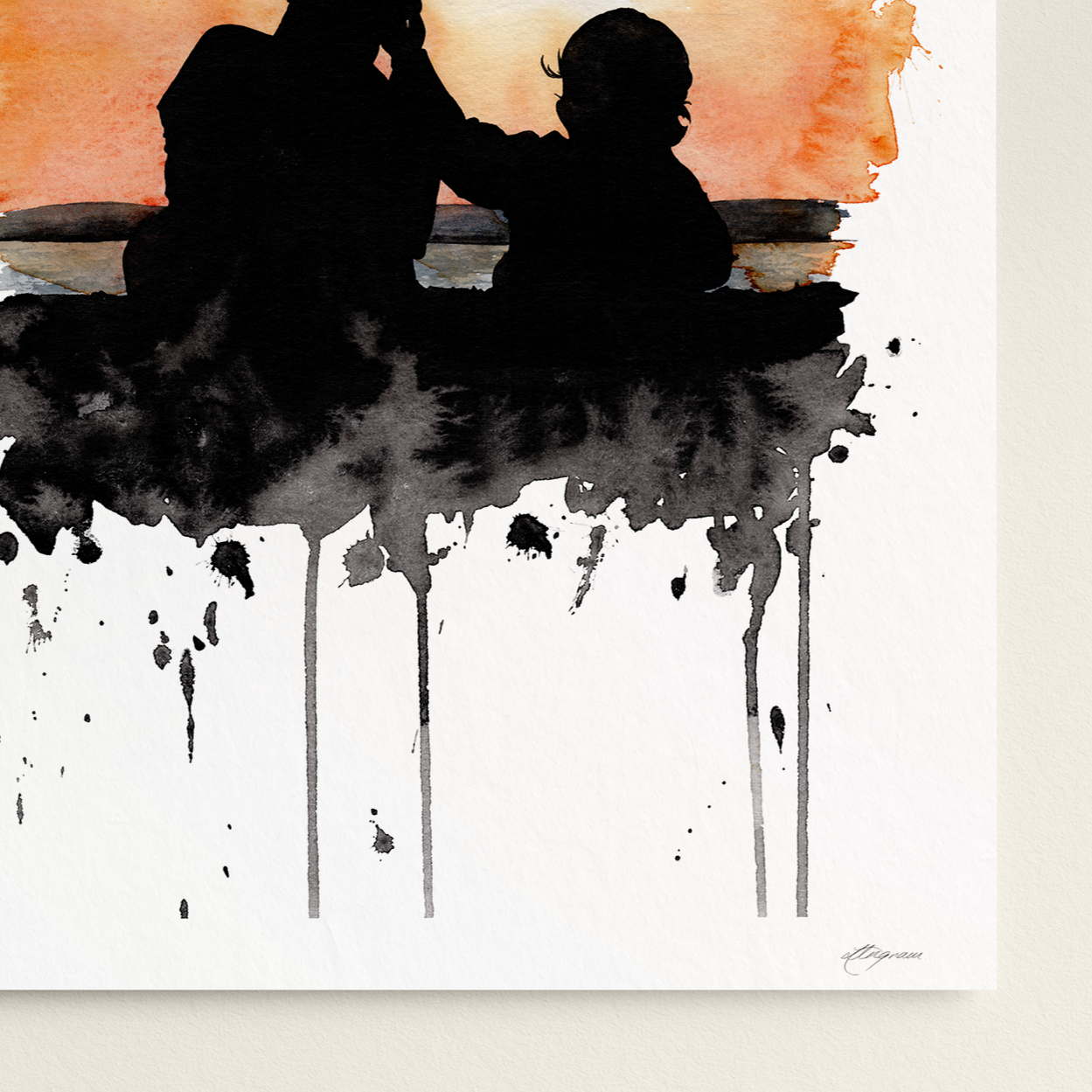Art print of a silhouette of a father and child against an abstract watercolor background on a white wall.