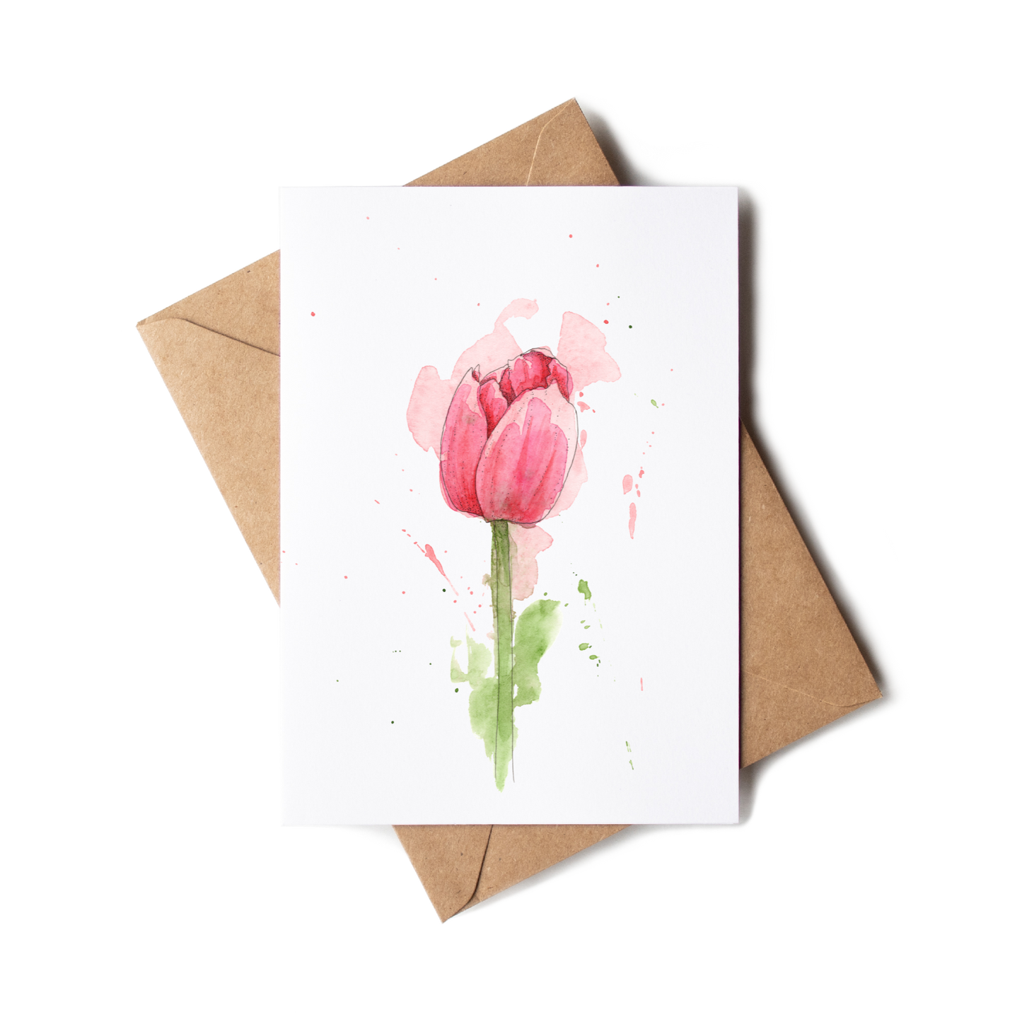 Greeting card with pink tulip design and brown envelope on white background