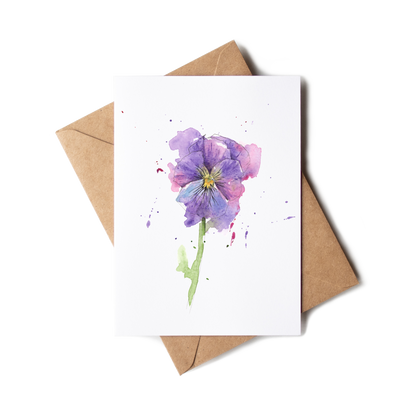 Greeting card with a purple flower illustration on a white background, accompanied by a brown envelope.