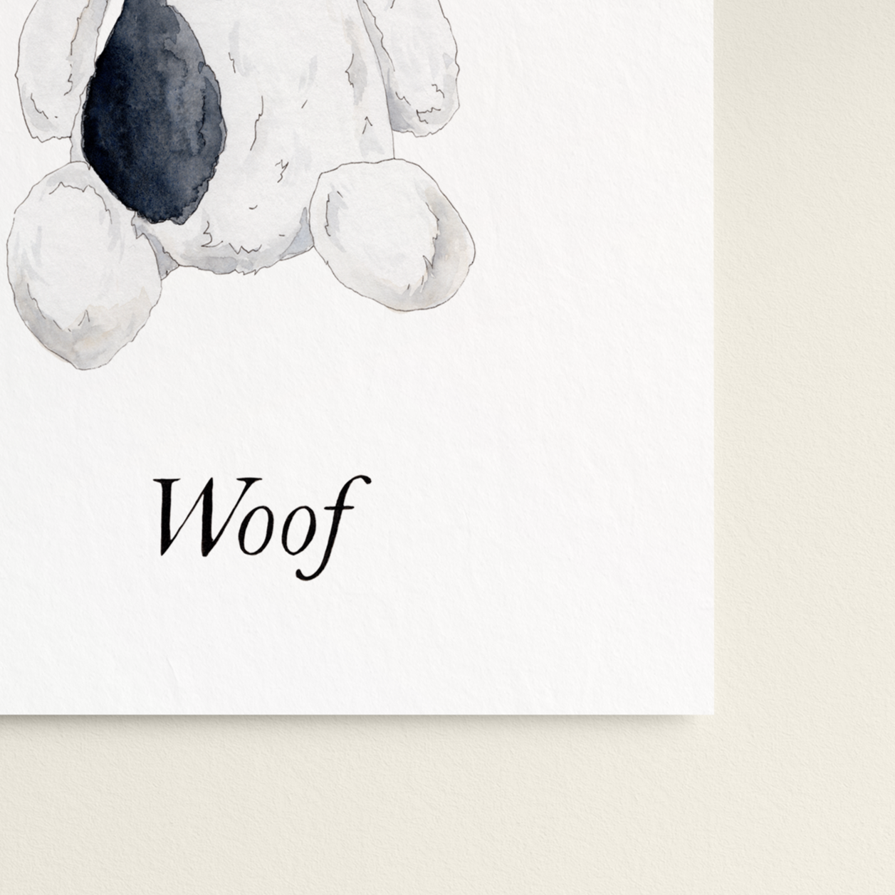 Stuffed dog toy with 'Woof' text on a white background